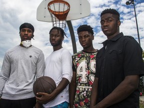 Nathan Dery, left, Philippe Jonathan Guerre, Kenley Louis and Shawn (last name withheld) are among a group of nine young Black men who came to a Repentigny park to play basketball in late May and left with a total of nearly $12,000 in tickets for not respecting COVID-19 measures. The Repentigny police force challenged the men's assertion that the fines were the result of discrimination.
