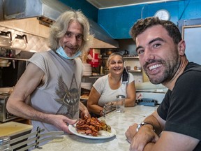 David Minicucci, the new owner of Cosmos, is served one last time by Nikos Koulakis and sister Niki Koulakis on Friday.