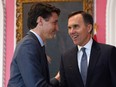 In this file photo taken on November 20, 2019, Canadian Prime Minister Justin Trudeau shakes hands with Minister of Finance Bill Morneau during a ceremony at Rideau Hall in Ottawa.