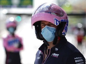 A Racing Point team member looks on in the pits during Friday practice for the Austrian Grand Prix. The race is being held Sunday without spectators.