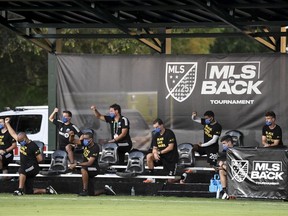 Montreal Impact players and staff on the bench take a knee prior to the game against the New England Revolution in the MLS is Back Tournament at ESPN Wide World of Sports Complex on July 9, 2020.