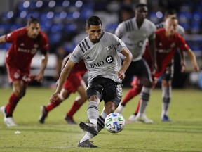 The Impact’s Saphir Taider scores on a 94th-minute penalty kick during 4-3 loss to Toronto FC at the MLS is Back Tournament on July 16 at the ESPN Wide World of Sports Complex in Reunion, Fla.