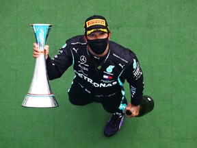 Race winner Lewis Hamilton of Great Britain and Mercedes GP celebrates on the podium after the Formula One Grand Prix of Hungary at Hungaroring on July 19, 2020 in Budapest, Hungary.