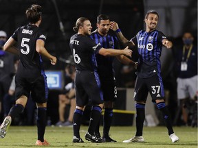 The Impact’s Saphir Taïder is congratulated by teammates after scoring goal during 31st minute of a 1-0 win over D.C. United in the MLS is Back Tournament Tuesday night at the ESPN Wide World of Sports complex in Florida.