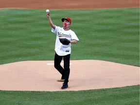 Dr. Anthony Fauci, director of the U.S. National Institute of Allergy and Infectious Diseases, throws out the ceremonial first pitch prior to the game between the New York Yankees and the Washington Nationals at Nationals Park on July 23, 2020 in Washington, DC.