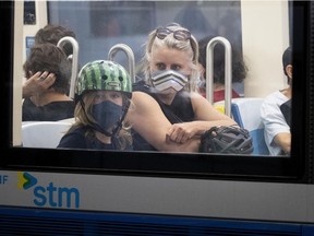 Rebecca and her son, Henri, ride the métro at the Berri-UQAM station in Montreal, on Tuesday, June 30, 2020. (Allen McInnis / MONTREAL GAZETTE)