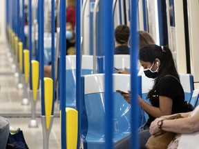 Montreal public transit users ride the métro in June 2020.