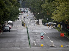 A resident leaves L'esplanade heading to the now closed to traffic Mont Royal Ave. in Montreal, on Monday, July 27, 2020. (Allen McInnis / MONTREAL GAZETTE) ORG XMIT: 64784