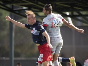 New England Revolution forward Adam Buksa (9) and Toronto FC defender Omar Gonzalez (44) head the ball during the first half at ESPN Wide World of Sports.