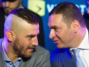 Promoter Camille Estephan speaks with boxer David Lemieux, left, during a news conference in Montreal on March 9, 2016.