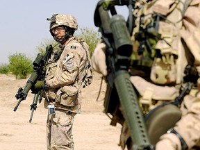 Canadian soldiers with the NATO-led International Security Assistance Force (ISAF) stand guard during a patrol in Panjwayi district, Afghanistan, in March, 2008. What should our relationship be with NATO today?