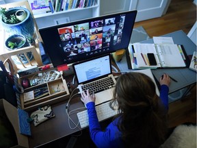 Lauryn Morley, a lower school substitute teacher for the Washington Waldorf School in Bethesda, Maryland, works from her home due to the Coronavirus outbreak, on April 1, 2020 in Arlington, Virginia.(Photo by Olivier DOULIERY / AFP)