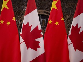 In this file photo taken on December 5, 2017, shows Canadian and Chinese flags taken prior to a meeting with Canada's Prime Minister Justin Trudeau and China's President Xi Jinping at the Diaoyutai State Guesthouse in Beijing. - China on July 4, 2020, accused Canada of meddling after Ottawa said it was suspending its extradition treaty with Hong Kong to protest a tough new national security law imposed there by Beijing. (Photo by Fred DUFOUR / POOL / AFP)