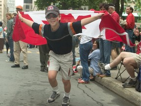 Captain Canada, a.k.a. 11-year-old Michael Wrobel, sports his new cape on Peel St. during the Canada Day parade in Montreal on July 1, 2004.