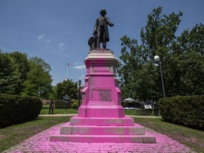 Demonstrators threw pink paint on a statue of Sir. John A. Macdonald at Queen's Park in Toronto on Saturday, July 18, 2020.