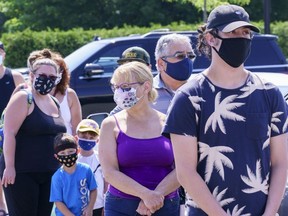 People line up to enter a mobile COVID-19 test clinic in Mercier on Thursday, July 9, 2020. A small community south of Montreal is making mask-wearing mandatory inside all commercial businesses following a COVID-19 outbreak authorities say is tied to a house party.