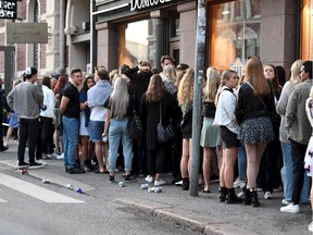 People queue in front of a night club after the coronavirus disease (COVID-19) restrictions for restaurants, bars and nightclubs were lifted, in Helsinki, Finland July 15, 2020.