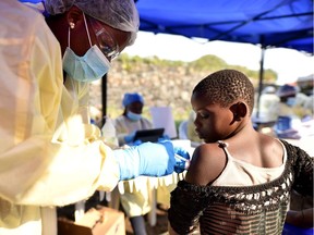 A Congolese health worker administers ebola vaccine to a child at the Himbi Health Centre in Goma, Democratic Republic of Congo, July 17, 2019. Building heath care capacity in lower income countries takes "the education and training of these professionals at strong post-secondary institutions located in their communities with high-quality, locally relevant health-care and public-health education programs," Greg Moran writes.
