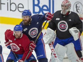 Canadiens defenceman Shea Weber defends against forward Tomas Tatar in front of goalie Carey Price Monday on first day of training camp at the Bell Sports Complex in Brossard as Phase 3 of the NHL’s Return to Play Plan began.