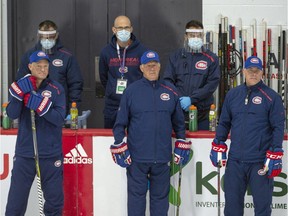 Canadiens head coach Claude Julien, centre, is flanked by assistant coaches Kirk Muller, left, and Domenic Ducharme, right, while watching practice at the Bell Sports Complex in Brossard on Monday.