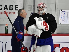 Carey Price speaks with Canadiens goalie coach Stéphane Waite during practice at the Bell Sports Complex in Brossard on Tuesday.
