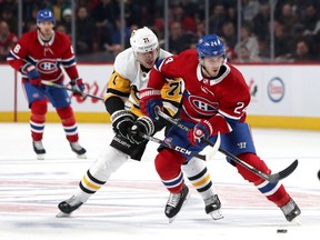 Canadiens centre Phillip Danault is checked by the Pittsburgh Penguins’ Evgeni Malkin during game at the Bell Centre on Jan. 4. The Penguins won the game 3-2 in overtime.