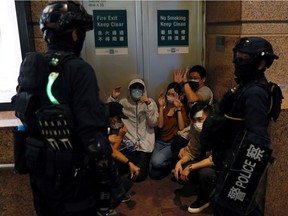 People are detained by riot police during a march against the national security law on the anniversary of Hong Kong's handover to China from Britain in Hong Kong, China July 1, 2020. REUTERS/Tyrone Siu/File Photo   To match Special Report HONGKONG-PROTESTS/SECURITY-POLICE