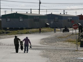 A family walks in Puvirnituq, on Hudson Bay in Nunsavik. "Two regional health boards controlled by Indigenous people, in Eeyou Itchee (James Bay) and Nunavik, and 28 health centres and nursing stations in First Nations communities, worked successfully to limit the spread of COVID-19, and to treat residents who were affected," Richard Budgell writes.