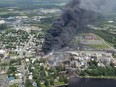 Smoke rises from railway cars that were carrying crude oil after derailing in downtown Lac-Mégantic on Saturday, July 6, 2013. Lac-Megantic is marking the seventh anniversary of a tragic rail disaster that claimed 47 lives by inaugurating a long-planned memorial space.