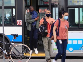 People get off the bus at the Vendôme Metro station on the first day that masks on public transit are mandated.