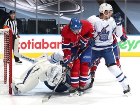 Goaltender Frederik Andersen (31) of the Toronto Maple Leafs falls in defence of Jordan Weal (43) of the Montreal Canadiens during the second period of the exhibition game prior to the 2020 NHL Stanley Cup Playoffs at Scotiabank Arena on July 28, 2020.