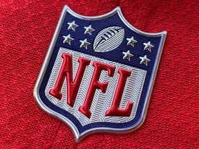 In this file photo taken on July 21, 2020, the official NFL logo is seen on the back of a hat in Los Angeles.