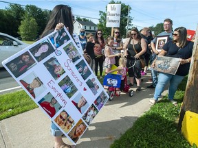 Family and friends of victims attend a march demanding an inquiry into the April mass shooting in Nova Scotia that killed 22 people, in Bible Hill, N.S. on Wednesday, July 22, 2020. Women's rights advocates in Atlantic Canada are calling on people across the country to join a brief general strike on Monday to demand a public inquiry into the deadly mass shootings that took place in Nova Scotia last April.