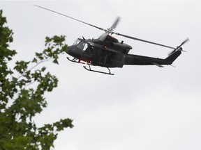 A Canadian Armed Forces helicopter searches the woods near St-Apollinaire on Saturday, July 11, 2020.