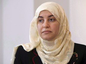 Rania El-Alloul takes part in a news conference Friday, March 27, 2015, in Montreal. A Quebec judge who refused to allow the Muslim woman to appear in court wearing a hijab in 2015 will apologize.