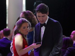 Prime Minister Justin Trudeau confers with his chief of staff Katie Telford at the National Press Gallery Dinner in Gatineau, Quebec, Saturday June 3, 2017.