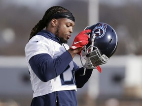 Tennessee Titans running back Derrick Henry puts on his helmet during an NFL football practice Thursday, Jan. 16, 2020, in Nashville, Tenn. The National Football League is turning to a Montreal university to solve one of the league's biggest headaches. Kollide-ETS, a group of four Montreal-based businesses and researches from engineering university Ecole de Technologie Superieure, recently won a grant from the NFL of about $330,000 to produce a football helmet that reduces the risk concussions.