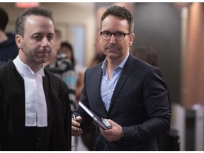 Former radio and TV personality Éric Salvail walks the halls of the courthouse in Montreal on Feb. 17, 2020.