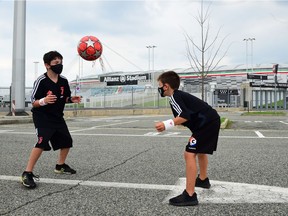 Children play outside Allianz Stadium in Turin, Italy, before a match, as games resume behind closed doors. One way to encourage kids to remain active during the pandemic is to promote physical activity the same way coaches and teachers do: organize it and schedule it.