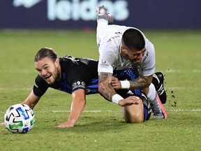 Impact midfielder Samuel Piette, left, and D.C. United defender Joseph Mora battle for the ball during the first half Tuesday night.