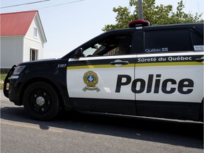 A Surete du Quebec car patrols the scene after an overnight tractor accident that saw three young children die in Notre Dame de Stanbridge, east of Montreal, on Thursday, July 2, 2020.