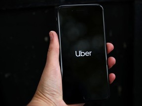 Uber's logo is displayed on a mobile phone.