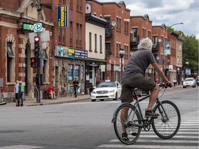 A man riding his bike near Little Burgundy in August 2020.