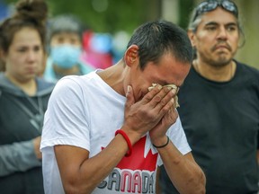 Putulik Qumak cries at a memorial Wednesday in Cabot Square for Kitty Kakkinerk and Dinah Matte. The Inuit women died after being hit by cars in separate incidents.