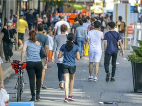 People walk on the pedestrian zone on St-Catherine St. in Montreal Wednesday August 5, 2020. (John Mahoney / MONTREAL GAZETTE) ORG XMIT: 64835 - 1107