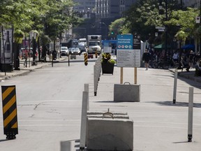 A large section of the Ste-Catherine Street pedestrian corridor sits empty during the Friday afternoon portion of the regular weekend closure to cars, seen in Montreal, on Friday, August 7, 2020.