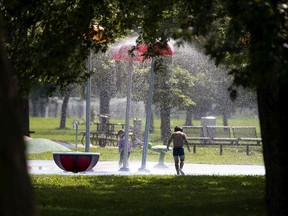 Kids run through a splash pad as they try to beat the heat in Montreal, on Tuesday, August 11, 2020. (Allen McInnis / MONTREAL GAZETTE)