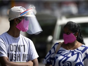 A man wears a face mask and shield on the streets of Montreal Aug. 12, 2020.