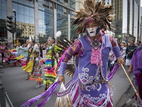 Members of the Indigenous community lead the Pride parade along Boulevard René-Lévesque in Montreal, on Sunday, August 20, 2017. This year, Montreal Pride Festival takes place in a digital format.