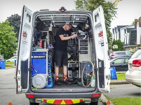 Sacha Gosselin tunes up a bicycle in his Vélofix mobile bicycle repair truck at a home in Dollard-des-Ormeaux on Monday Aug. 24, 2020.
